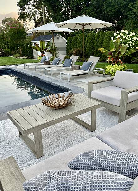 istock Beautiful, luxury, modern backyard lounge area. Umbrella, sofa, lounge chairs table poolside. Hotel resort feel. Seating and tanning sundeck by gray stone pavers. Inspired by Tulum, Mexico. High end. 2228545853