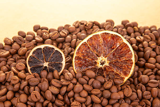 istock Rustic still life featuring dried orange segments scattered over a bed of rich, roasted coffee beans. coffee aroma and taste descriptors 2228546068