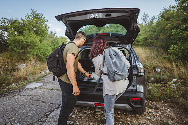 istock Hikers preparing backpacks in car trunk before hiking trip 2228547340