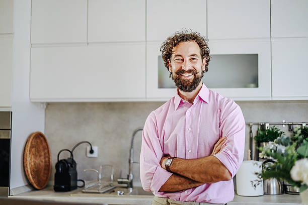 istock Portrait of smiling manager with folded arms in modern kitchen 2228551284