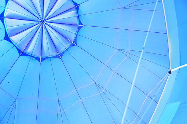 istock View from a hot air balloon basket, looking up at the burner flame heating the blue envelope during flight 2228551303
