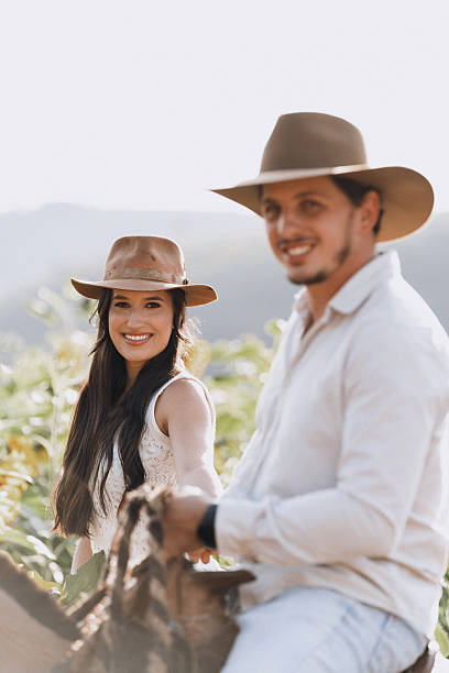 istock Couple smiling on horseback in countryside 2228552833