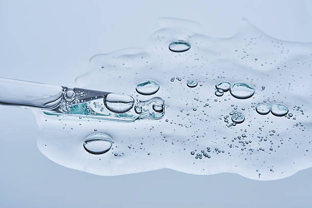 istock Transparent serum with bubbles and dropper dropper on a blue background. 2228553590