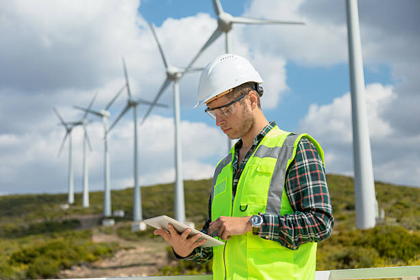 istock Engineer Man Using Digital Tablet for Wind Turbine Inspection at a Wind Farm for Renewable Energy Projects 2228557266