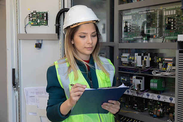 istock Confident Female Engineer Conducting Maintenance and Technical Inspection in High-Tech Control Room of Renewable Energy Power Station 2228557606