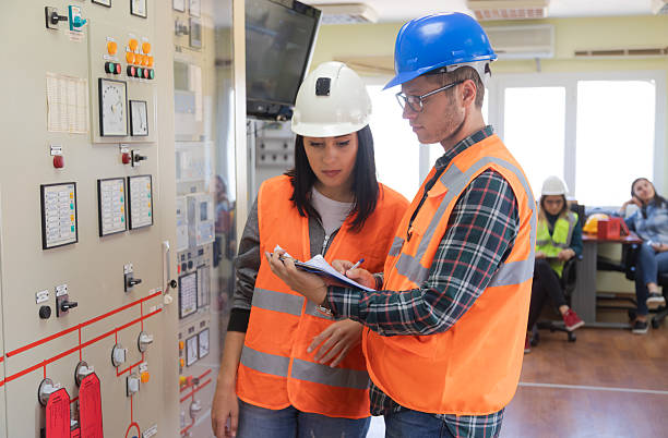 istock Engineers Collaborating in Modern Control Room of Renewable Energy Facility for System Monitoring and Safety 2228557853