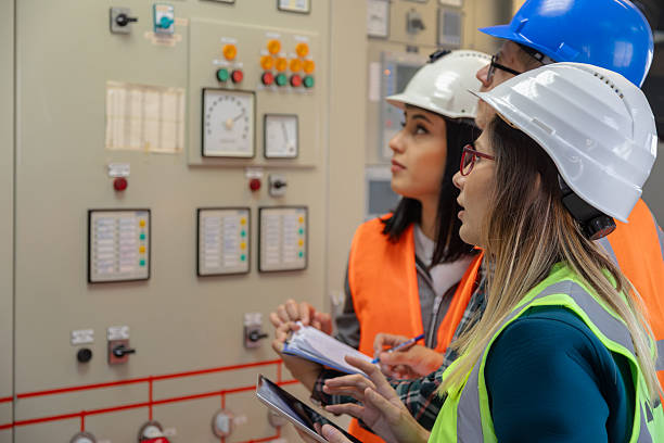 istock Team of Engineers and Technicians Monitoring Control Panel in Modern Renewable Energy Facility 2228557885
