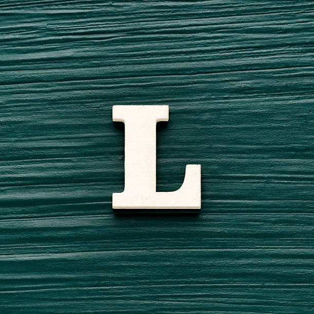 istock Capital letter L, White letter on a rustic dark green background 2228558038
