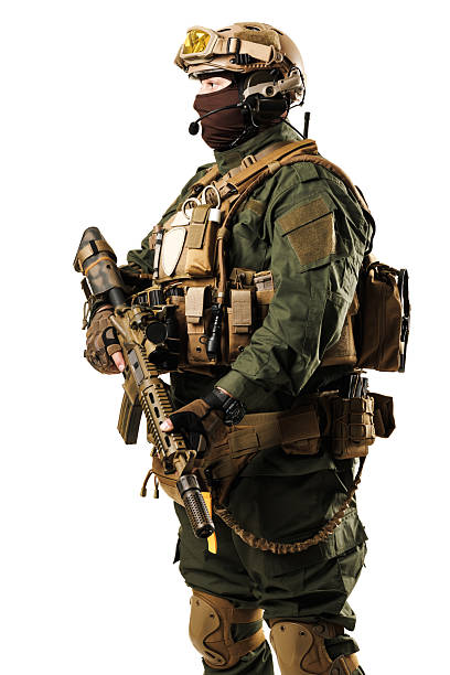 istock Soldier in Tactical Gear Holding Rifle in Isolated Studio Setting 2228558375