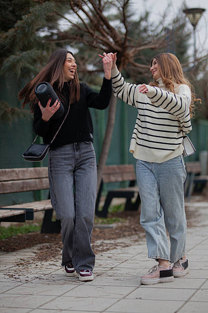 istock Two friends dancing outdoors enjoying music and laughing on a joyful day 2228558452