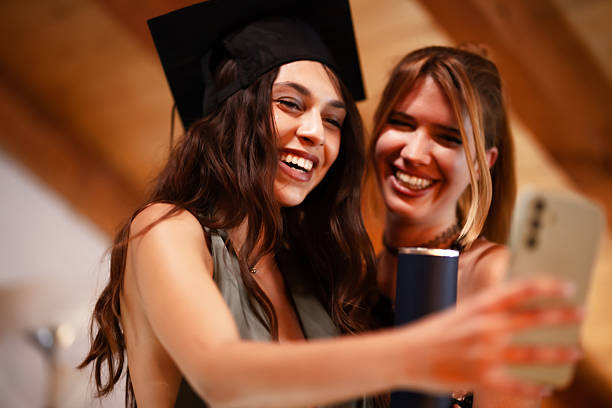 istock Two friends taking a selfie during graduation celebration indoors 2228558680