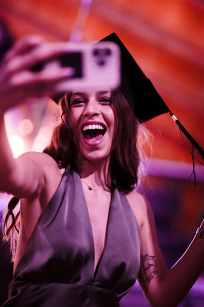 istock Woman Celebrating Graduation and Taking a Selfie with a Joyful Expression 2228558757