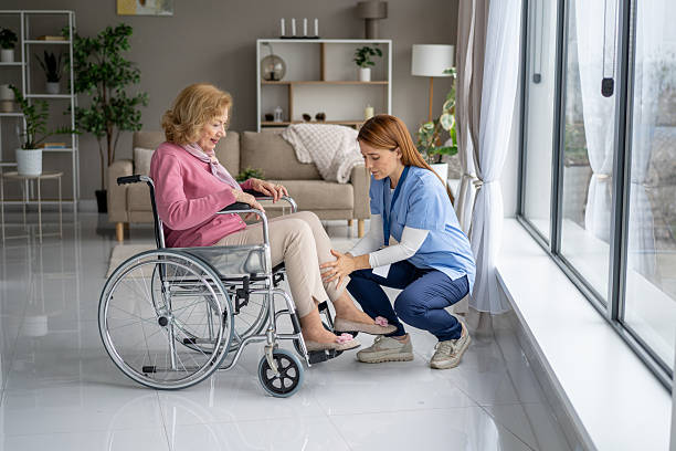 istock Nurse Gently Supporting Elderly Client in Wheelchair 2228558862