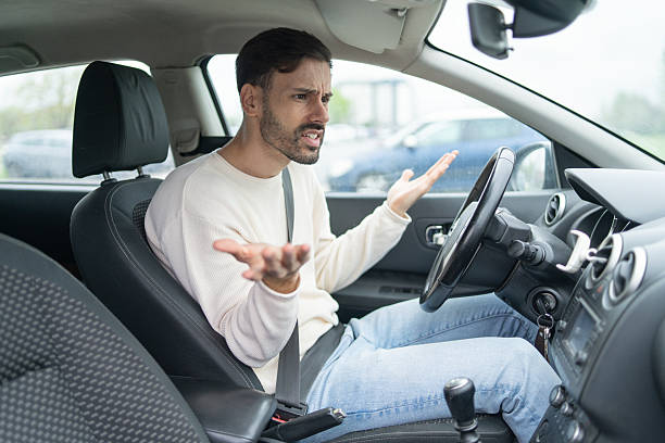 istock Upset driver expressing anger with gesturing hands in car. 2228559080