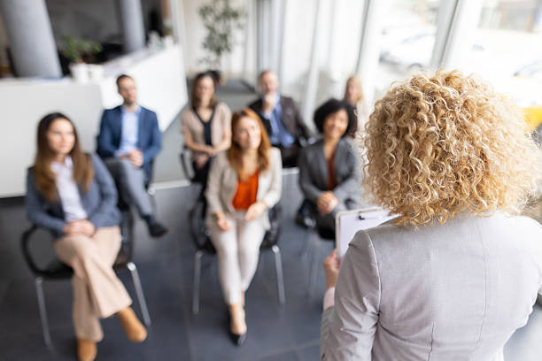 istock View of a Confident Speaker Addressing Engaged Participants 2228560585