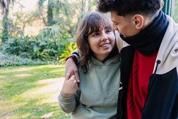 istock Young couple sharing a tender moment in the park 2228560918