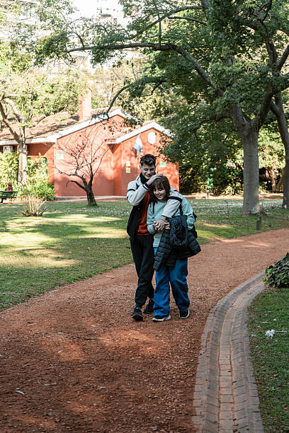 Teenagers walking in a park, enjoying their time together