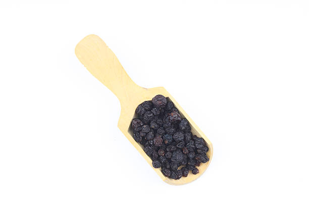 raisins in a scoop isolated on white background