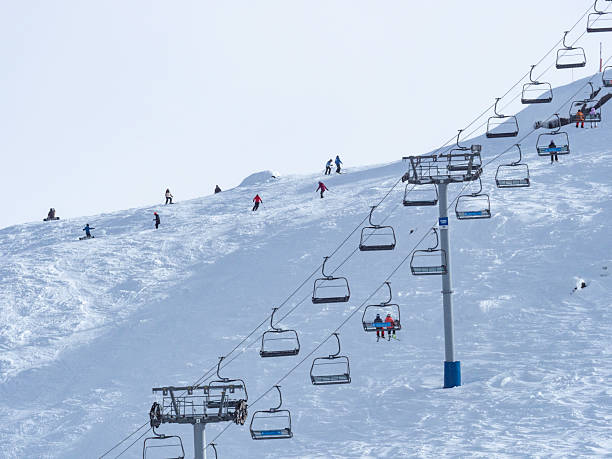 istock Ski lift and skiers on mountain 2228562801