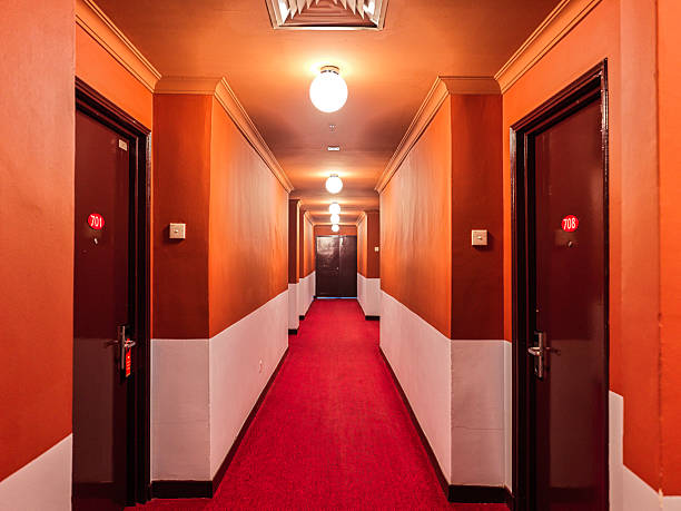 istock Colorful Hotel Hallway with Red Carpet and Warm Lighting 2228564344