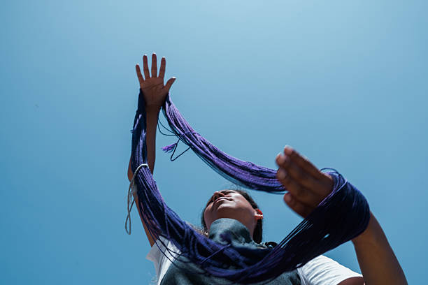 istock Female artisan stretching wool by hand 2228570385