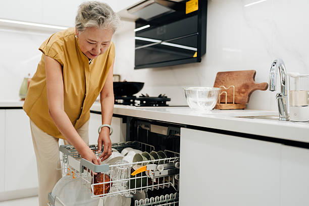 istock Asian senior woman using dishwasher in the kitchen. 2228573616