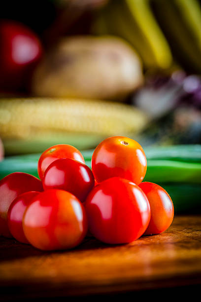 Healthy eating: Close-up of cherry tomatoes on a cutting board in a rustic kitchen. Natural lighting