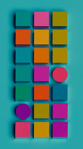 istock Top-down view of colorful 3D cubes and cylinders on teal surface 2228574826