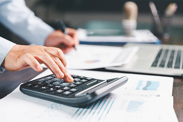 istock Office businesswoman hand to operate calculator analyzing financial data, counting costs on desk. accounting, financial analysis for business budget planning, calculation support, finance management. 2228576532