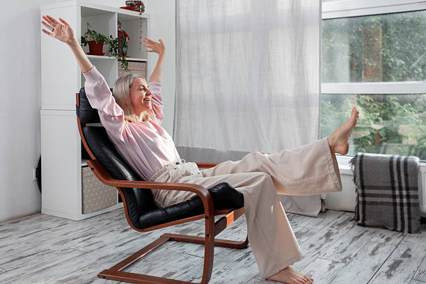 istock Happy middle aged Woman sits at Home 2228582124