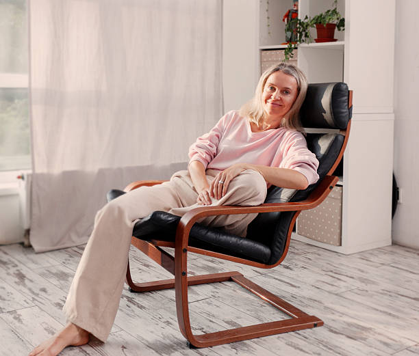 istock Happy middle aged Woman sits at Home 2228582125