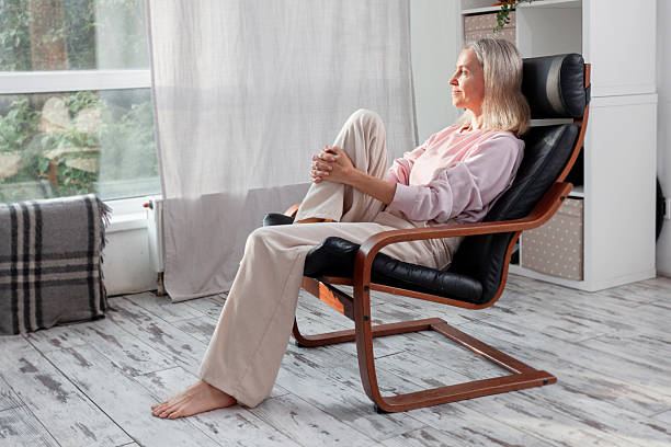 istock Happy middle aged Woman sits at Home 2228582131
