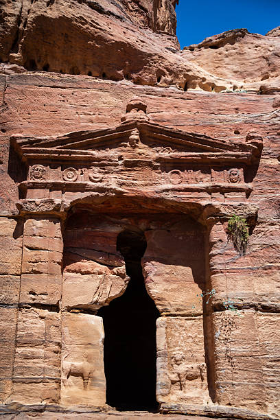 Vertical view of the entrance to the Lion Triclinium in Petra, Jordan