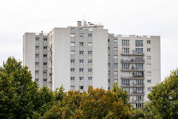 istock Residential tower block seen behind tree tops 2228583864