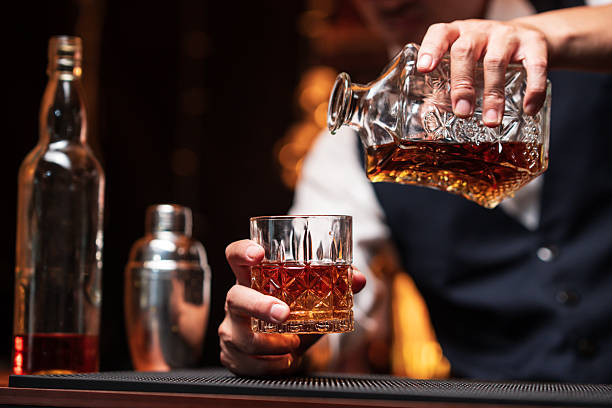 istock Bartender is pouring whiskey into a glass in a restaurant 2228587824