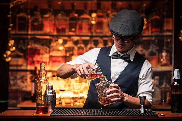 istock Bartender is pouring whiskey into a glass in a restaurant 2228587833