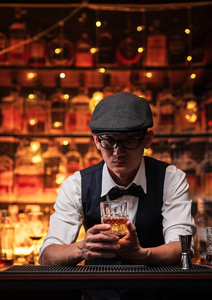 istock Bartender is pouring whiskey into a glass in a restaurant 2228588851