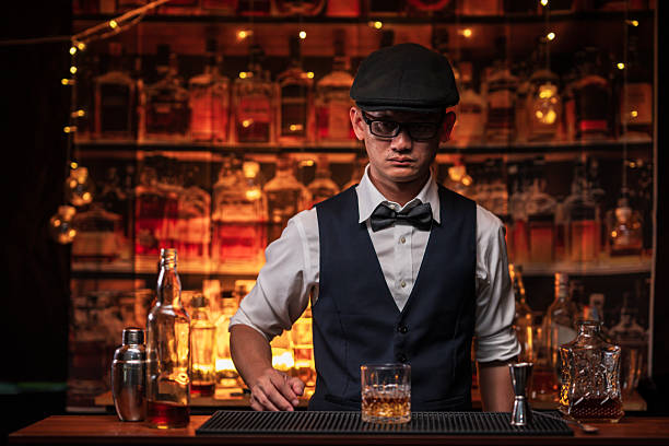 istock Bartender is pouring whiskey into a glass in a restaurant 2228588881