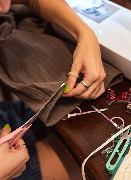 istock Young fashion designer is working on material in tailor studio. 2228589408