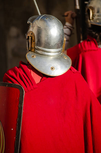 istock A Roman soldier with a shield, seen from behind at a historical reenactment. 2228590112