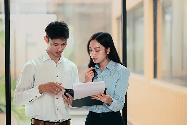 istock Two businesspeople discussing project details, reviewing documents and data in an office 2228590261