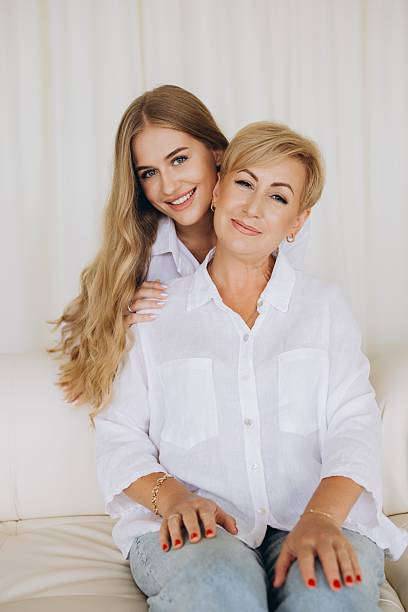 istock Mother and Daughter Sharing a Tender Moment on Sofa 2228590282