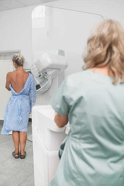 istock A nurse helps a patient undergo a mammogram procedure. vertical 2228590659