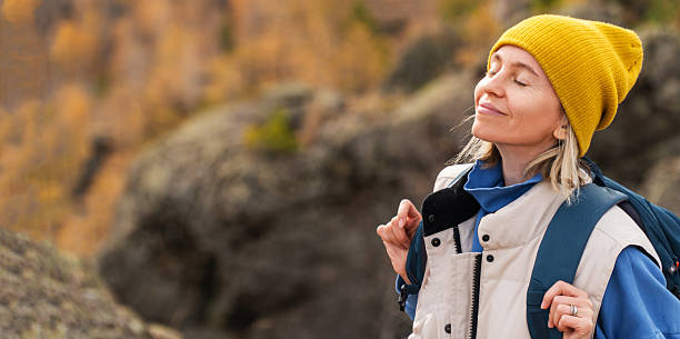 istock Middle-aged Woman hiking in the Mountains with Backpack 2228590824