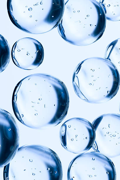 Transparent blue water bubbles floating on a light background. Abstract 3D render symbolizing hydration, freshness, purity, and skincare. Clean minimal concept for cosmetic or science themes.