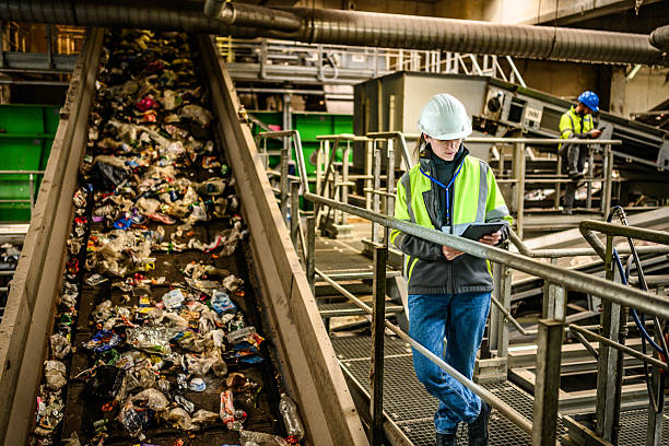 istock Female Worker Monitoring Waste Processing in Industrial Facility 2228593368