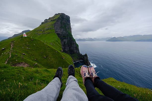 istock Exploring breathtaking cliffs and serene waters in the Faroe Islands on a cloudy day 2228594588