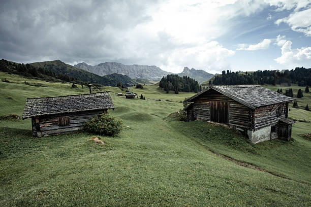 istock small house over a mountain pasture in Dolomites with wonderful panorama 2228597404