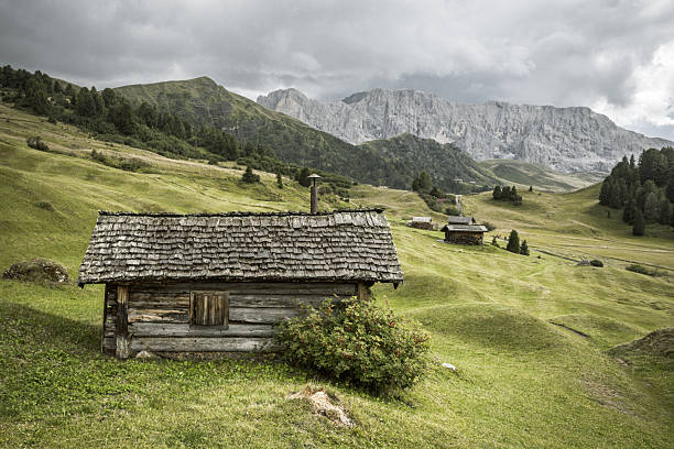 istock small house over a mountain pasture in Dolomites with wonderful panorama 2228597439