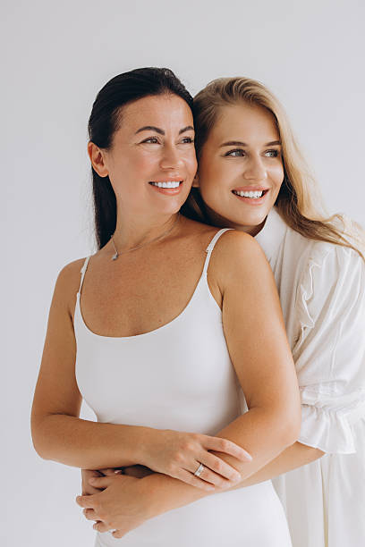 istock Mother and daughter hugging and smiling, wearing white clothes 2228598578